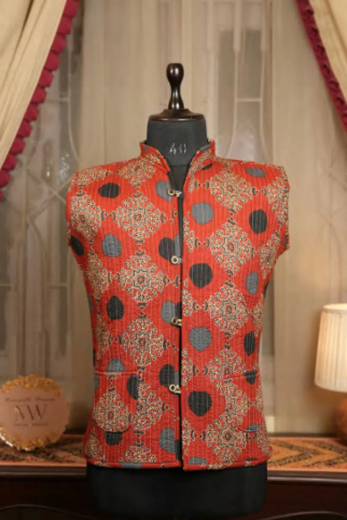Red patterned sleeveless Nehru vest with stand collar and button front, gold details