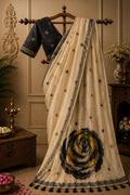 Cream saree with dark floral rosette applique and star motifs, striped border.
